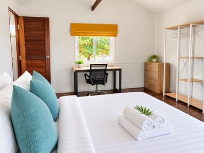 Beach house bedroom with a desk and office chair by the window