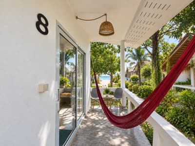 Red hammock on the shaded terrace outside beach studio number eight